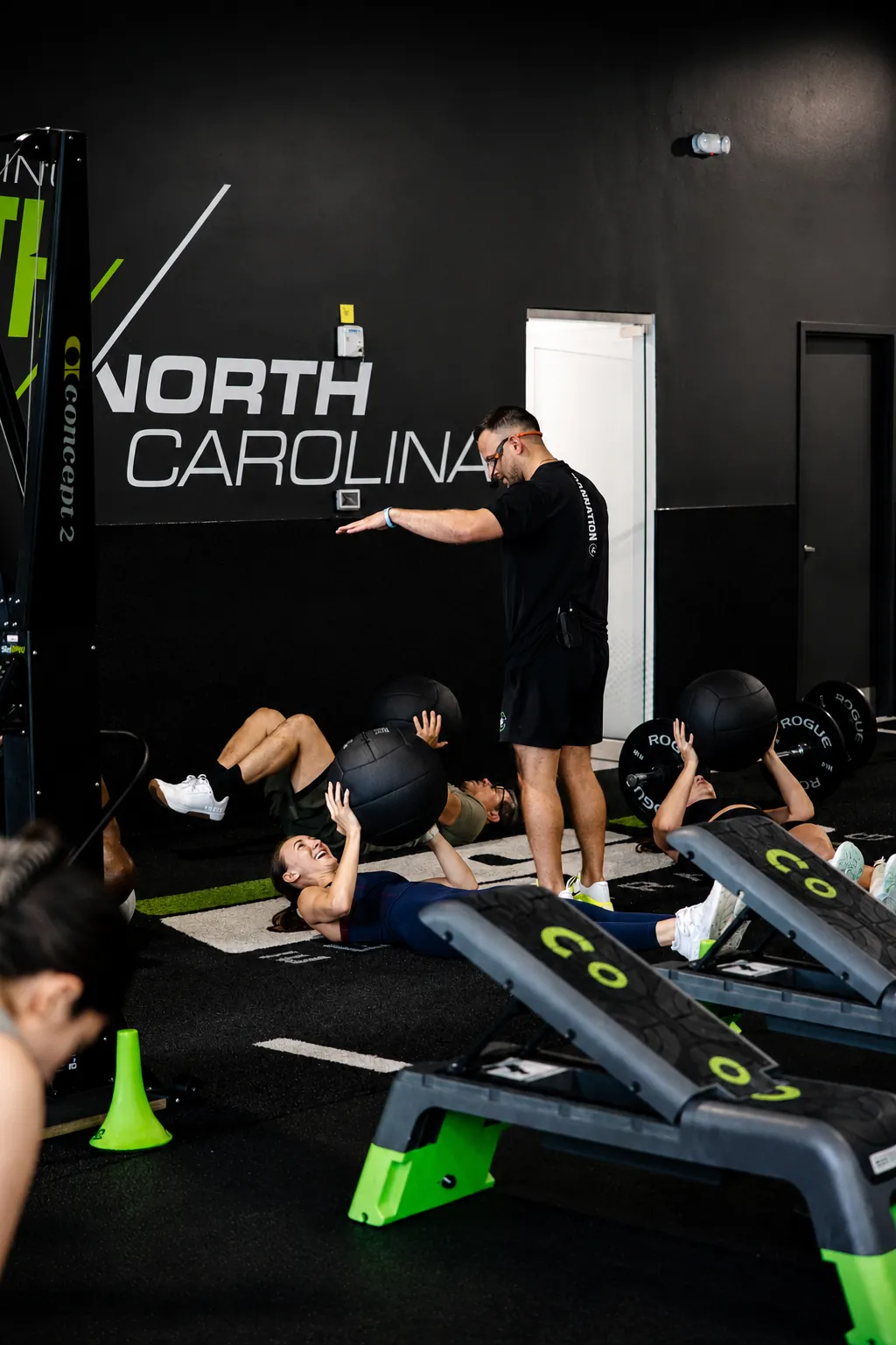 An ISI coach leading members through a medicine ball exercise