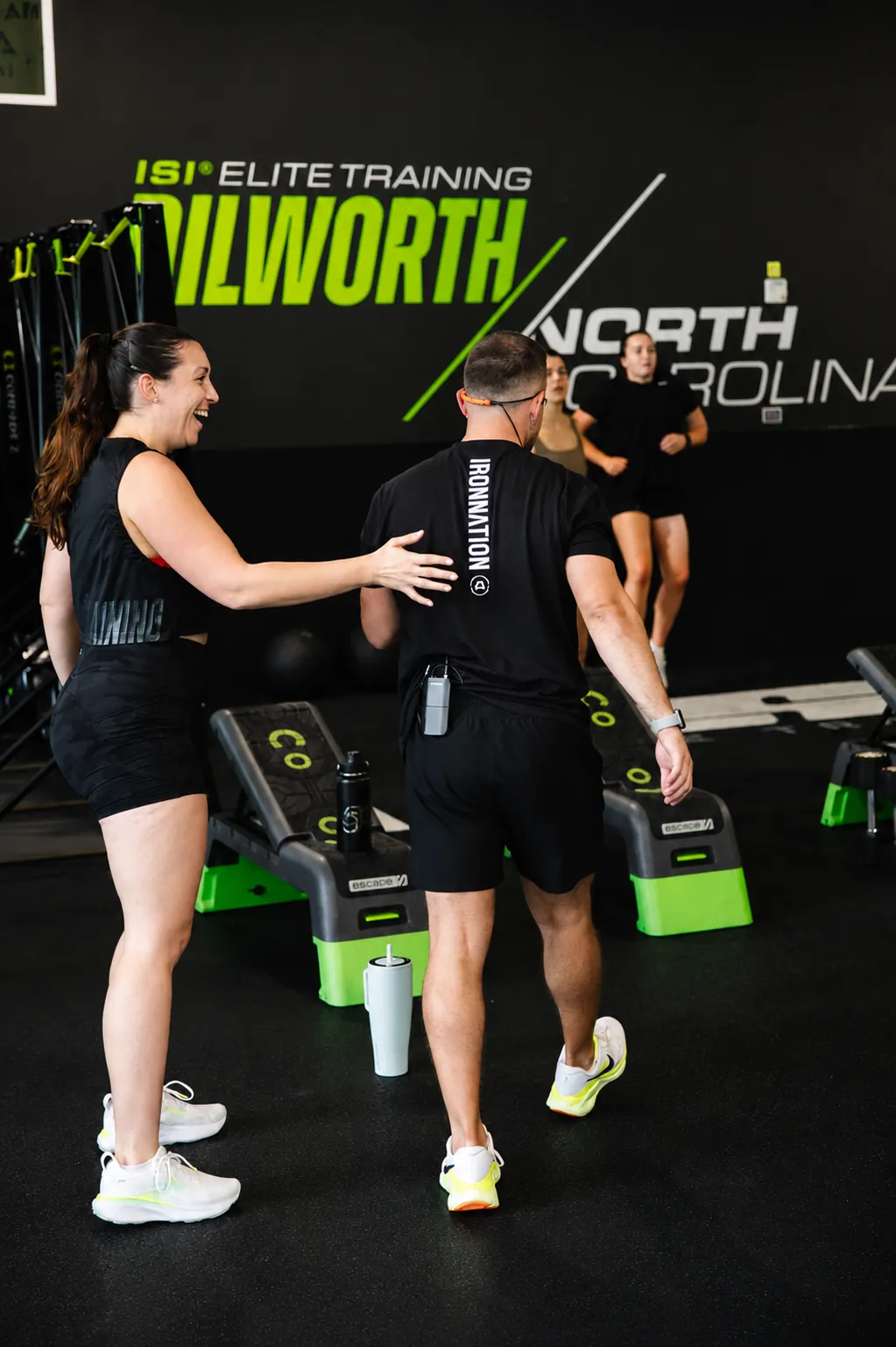 ISI Elite Training members and a coach sharing a moment during a workout